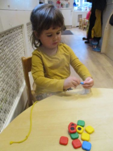 Basingstoke children practice threading beads