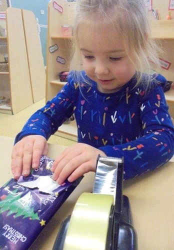 Leeds nursery children embrace wrapping presents