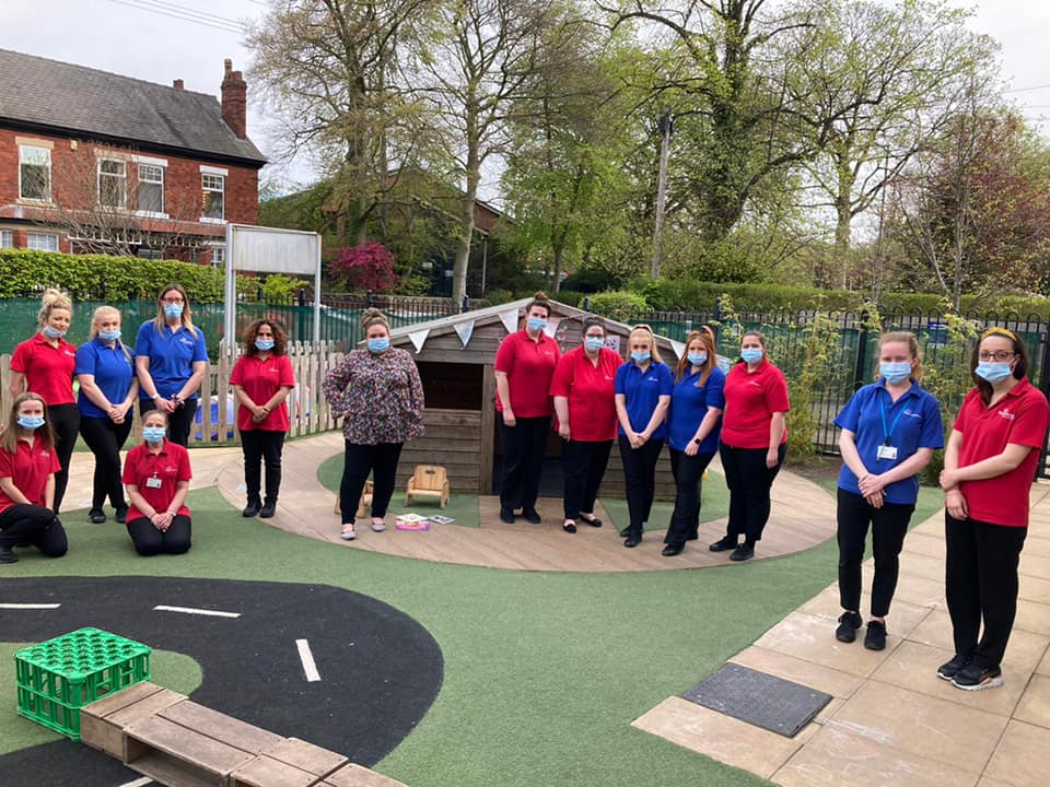 A group of nursery workers in a nursery garden