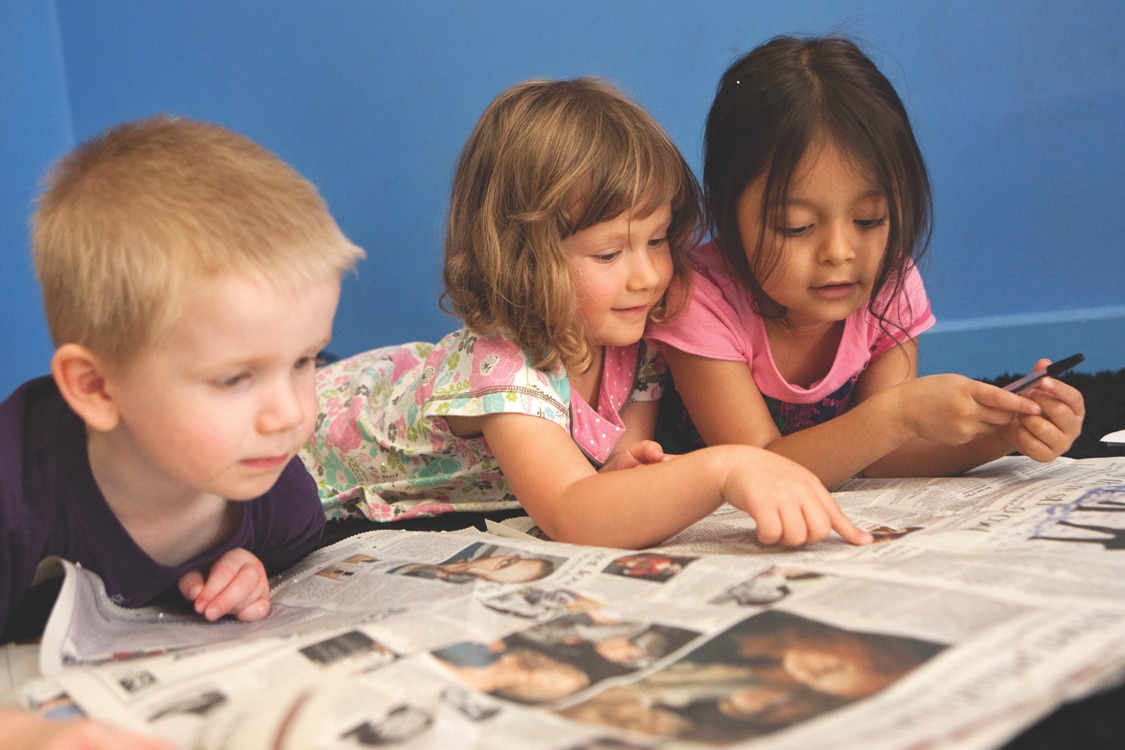 Kids Reading a Newspaper