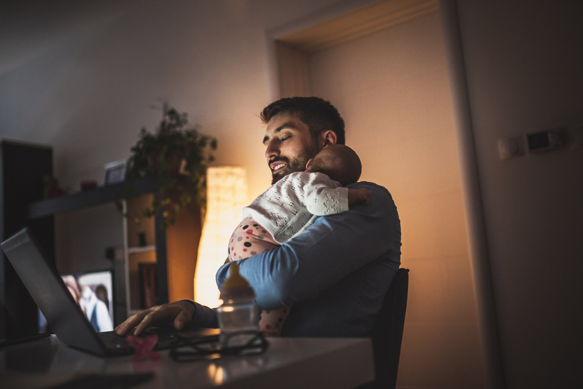 Father Holding Baby while working