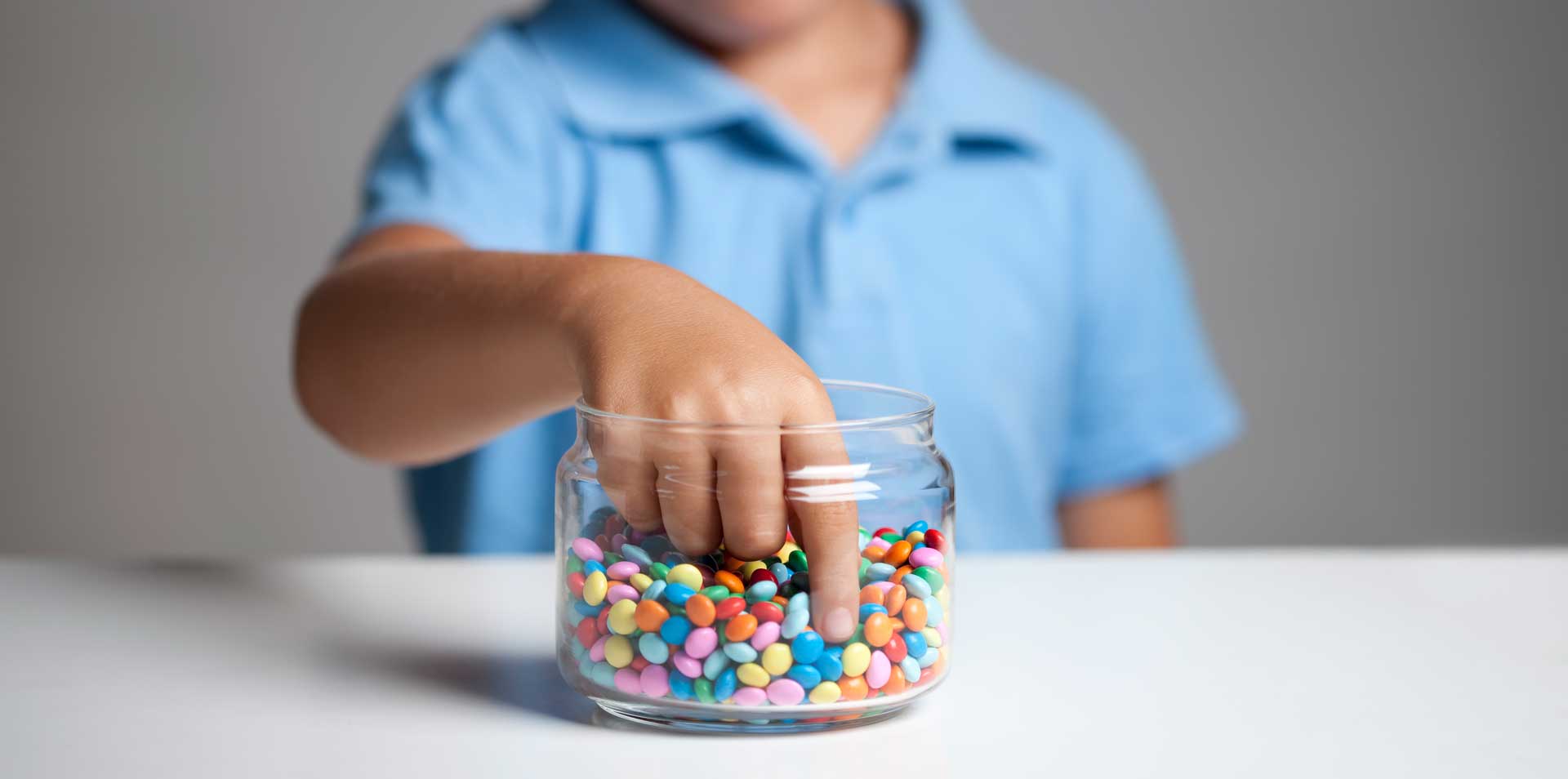 A child with his hand in the sweet jar