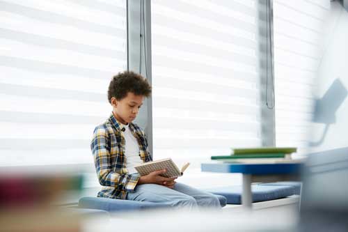 Teenage boy reading a book