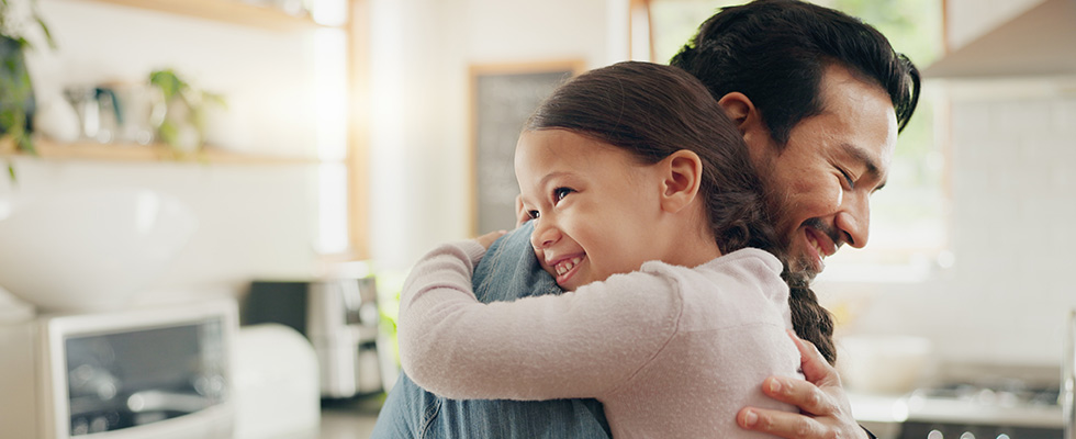 Father hugging daughter in the morning