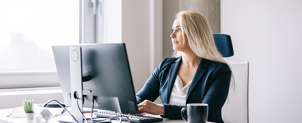 Business women working and reflecting at work